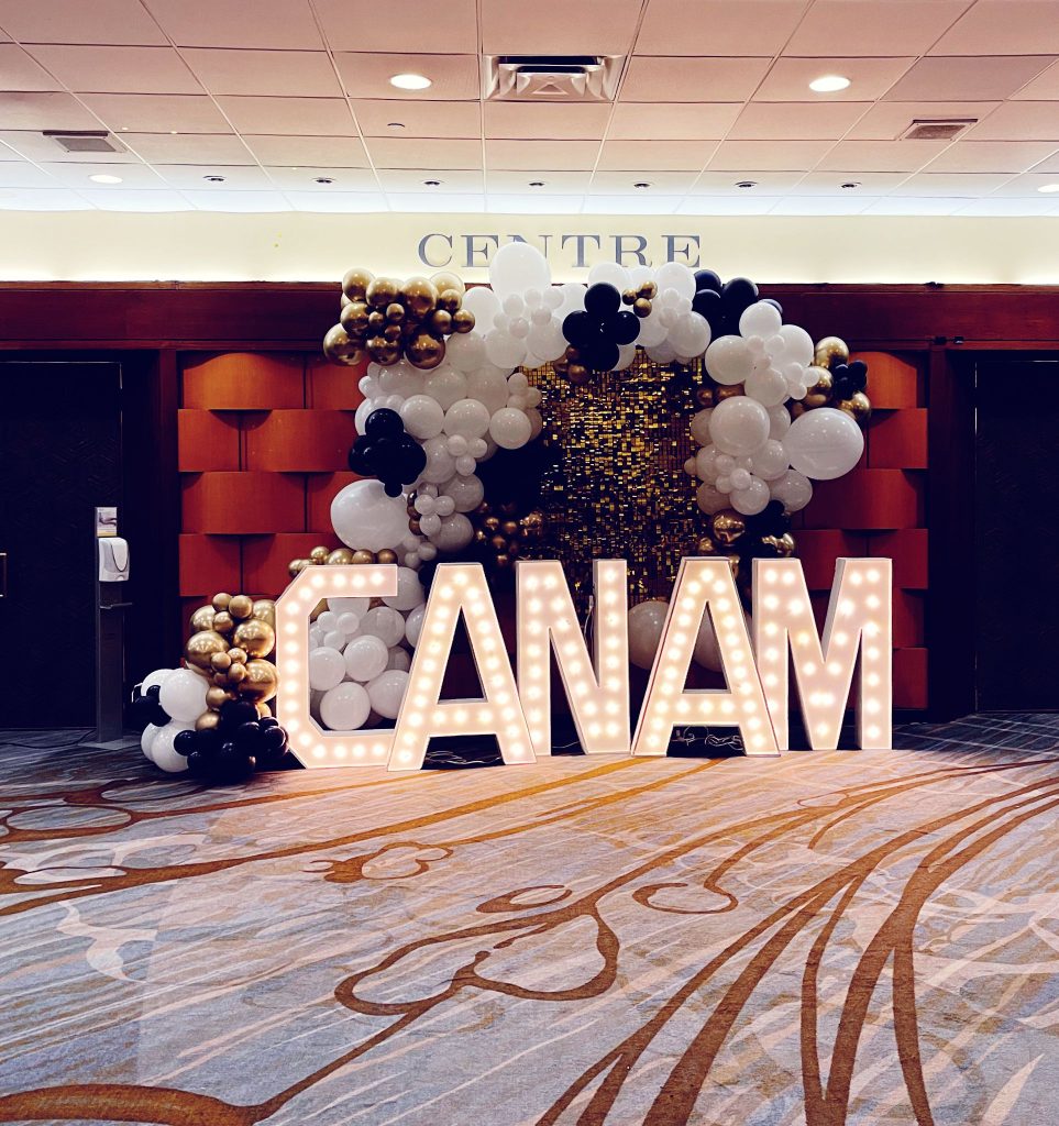 Guelph marquee letters spelling out CANAM and balloon arch framing the letters
