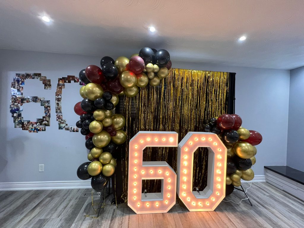 Rent Guelph marquee numbers with a backdrop and balloon decor framing the set-up