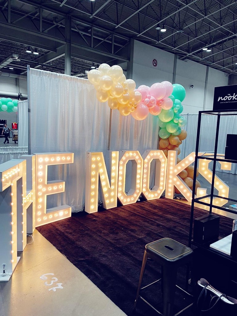 Rent Oakville marquee letters with white drapes and a balloon garland framing the decor.