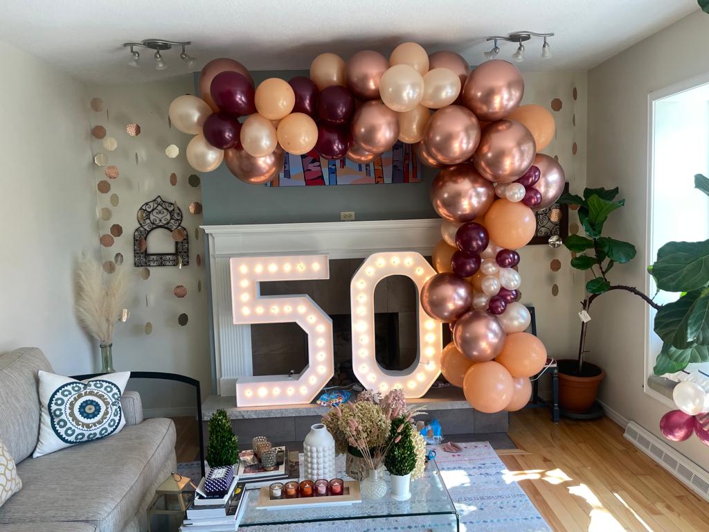 Oakville marquee numbers with a balloon garland framing the age displayed.